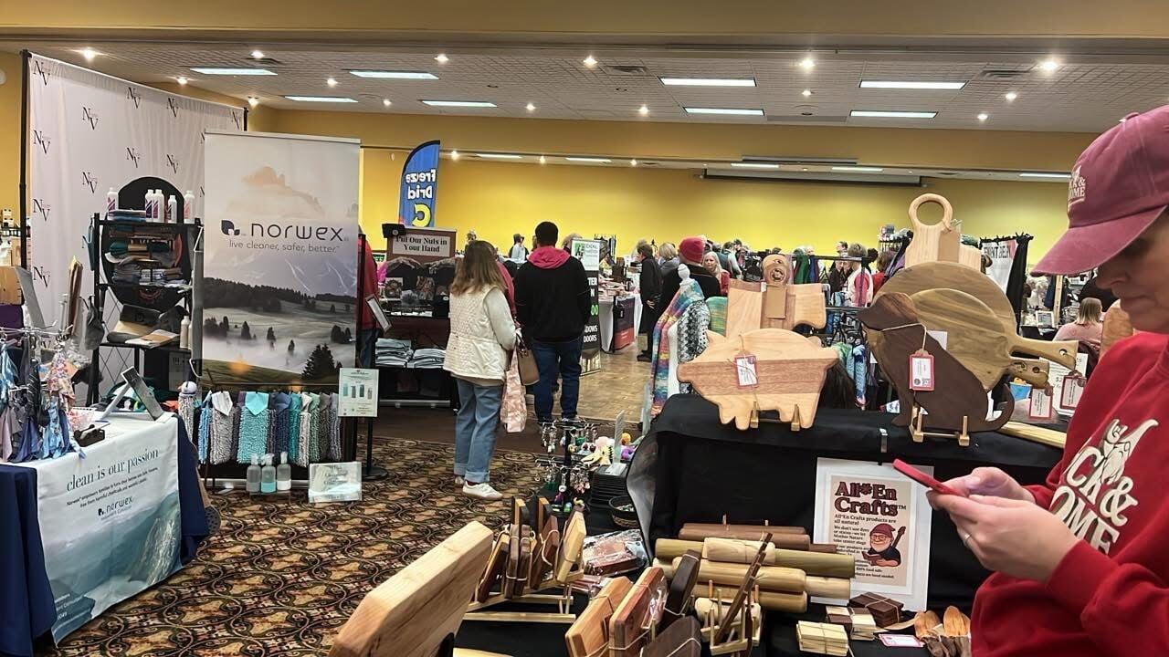 Lexie Allen of All En Crafts LLC recording a sale by mobile phone at the Ames Lotta Love vendor event in February 2026.